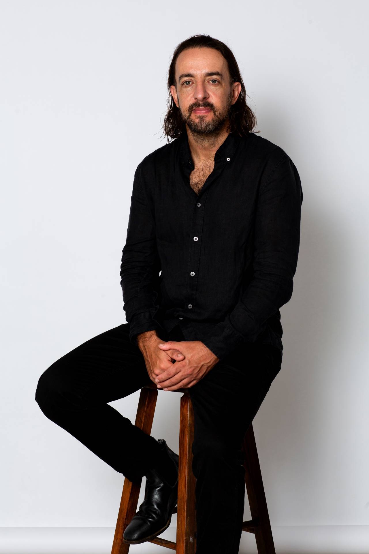 Picture of Dave Baskind sitting on a stool thinking.